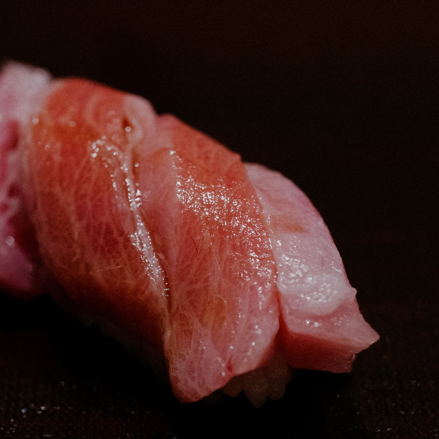 Close-up of fatty tuna sushi with marbled texture.