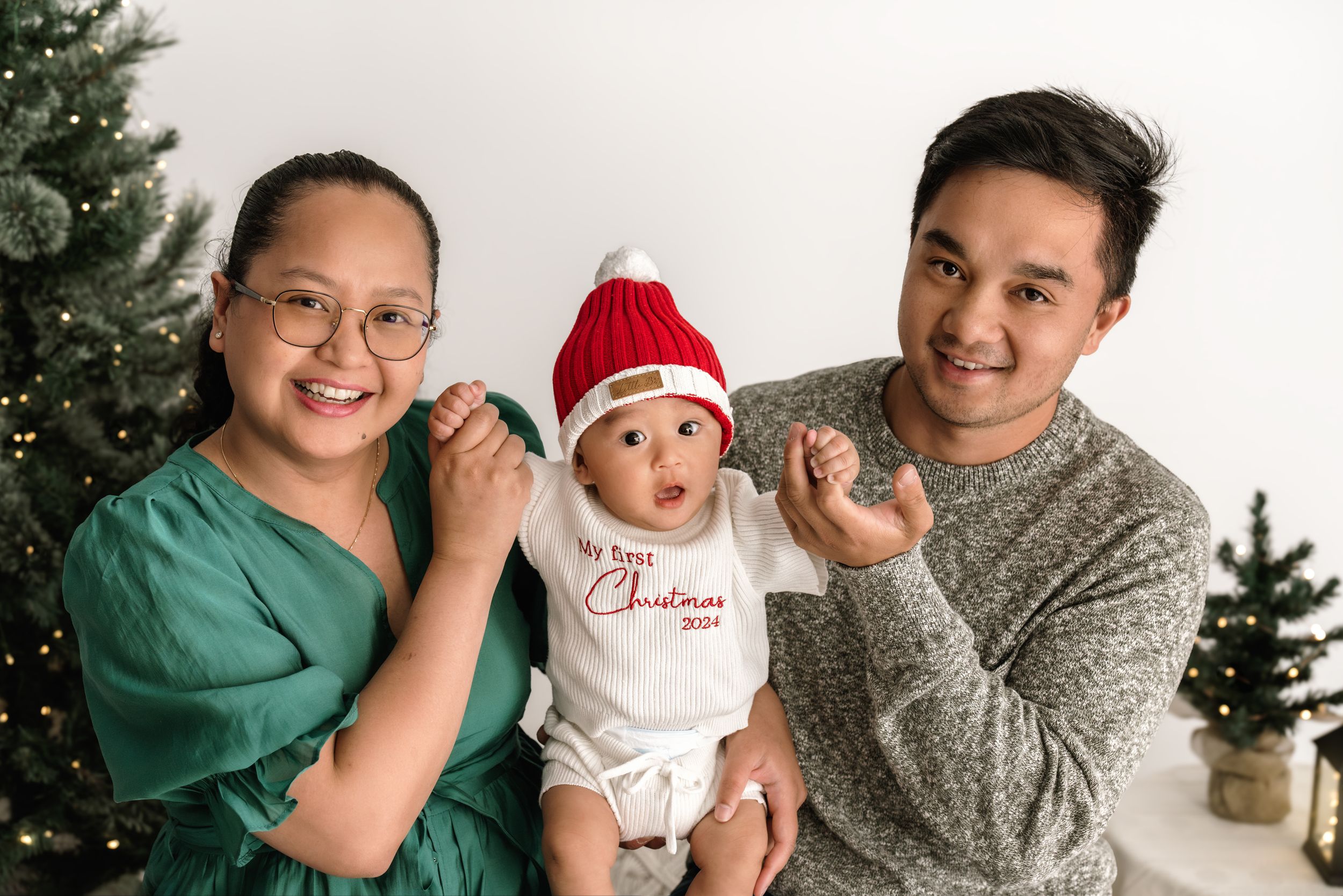 A series of holiday family portraits in front of a Christmas tree showing warm moments and festive spirit.