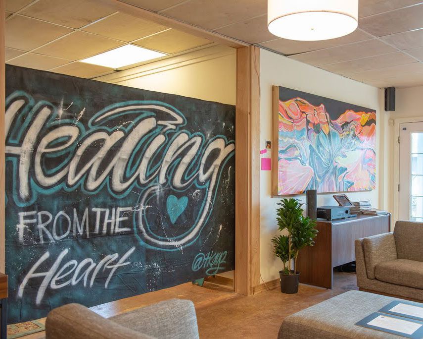 Interior wall art displaying 'Healing from the Heart' text in stylized lettering with colorful designs.