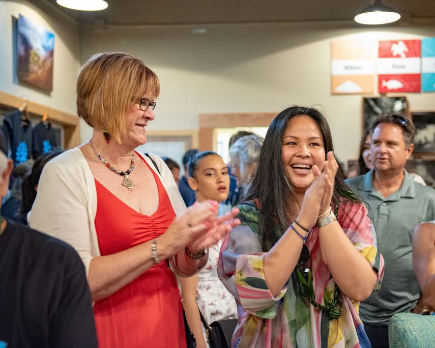 An exciting moment of celebration and applause at an indoor gathering.
