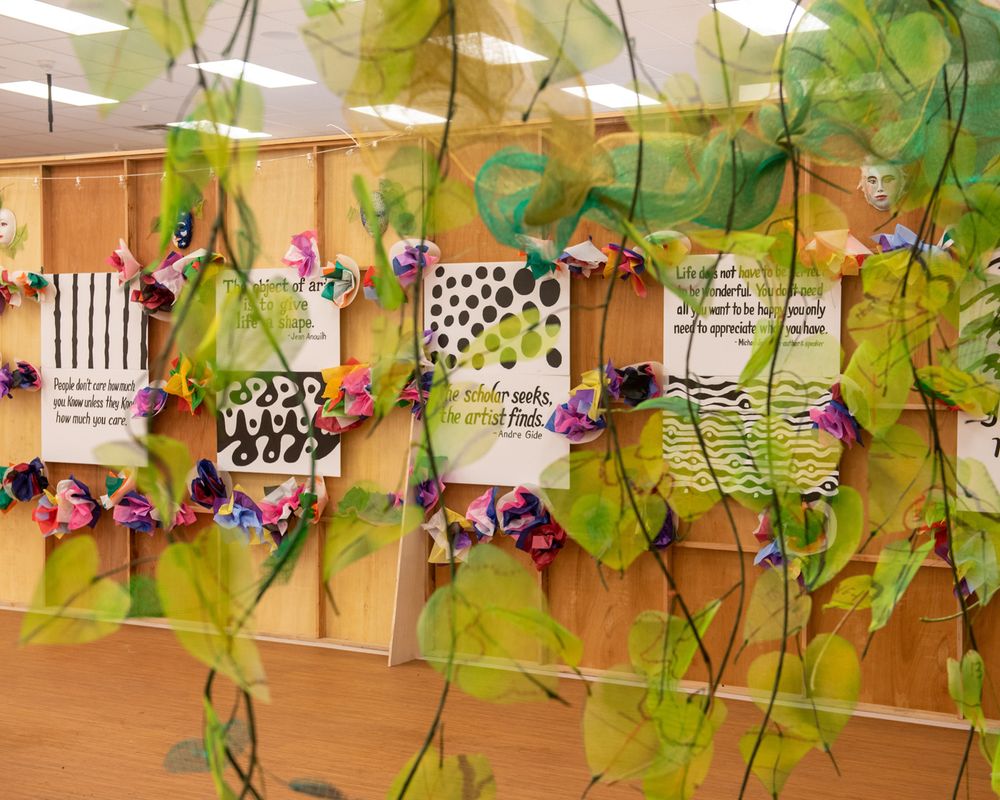 Decorative vines and cards with patterns adorn a wall display.