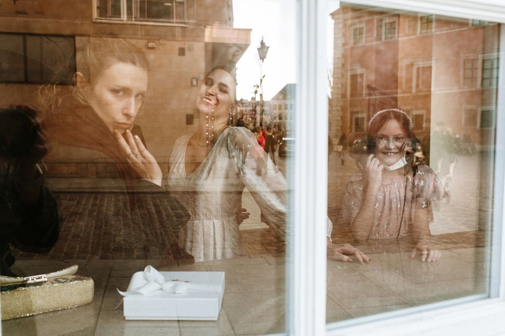 Double exposure photograph showing reflections of people in a cafe window with a vintage sepia-toned effect.