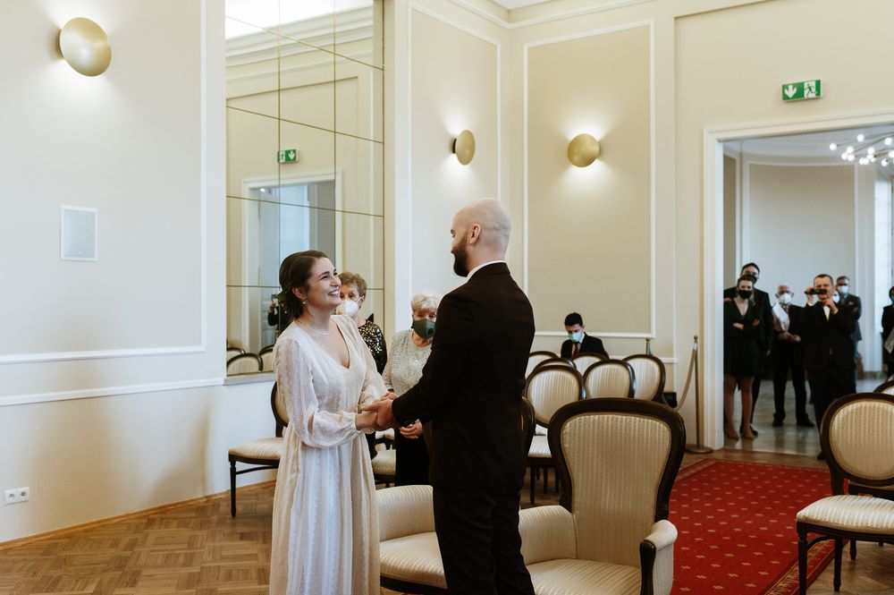 A series of photos showing a wedding ceremony in an elegant room with white walls and red carpeting.