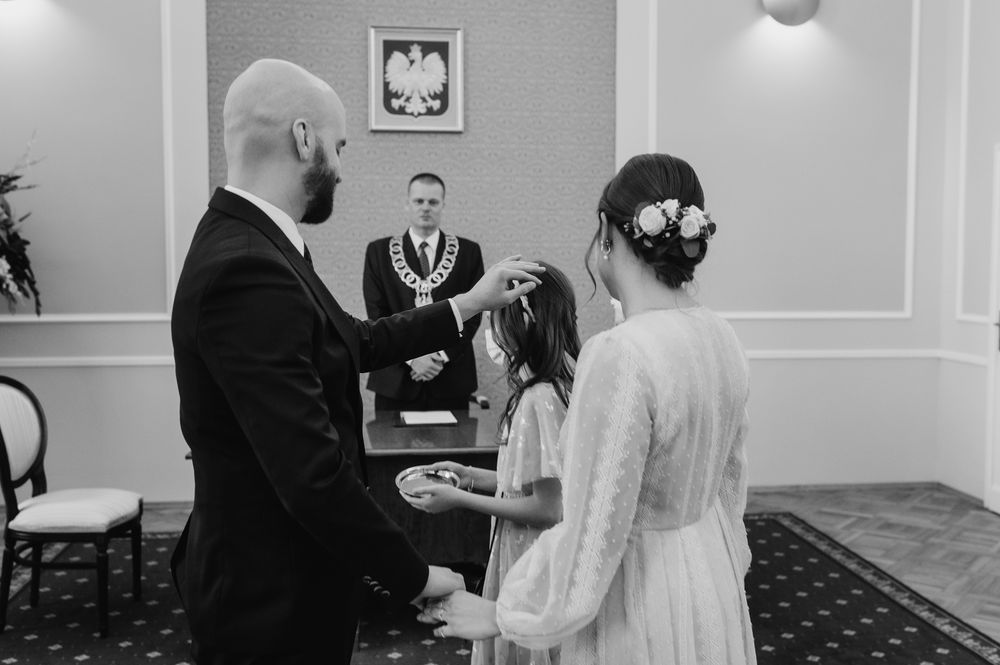 Black and white photo montage showing different moments from an elegant indoor wedding ceremony.