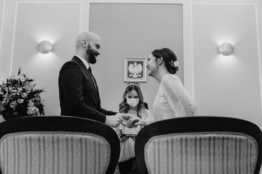 Wide panoramic collage of wedding ceremony moments in black and white showing interior venue details.