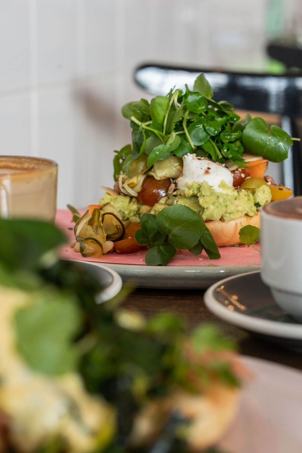 Close-up view of plated dishes garnished with fresh microgreens in a restaurant setting.