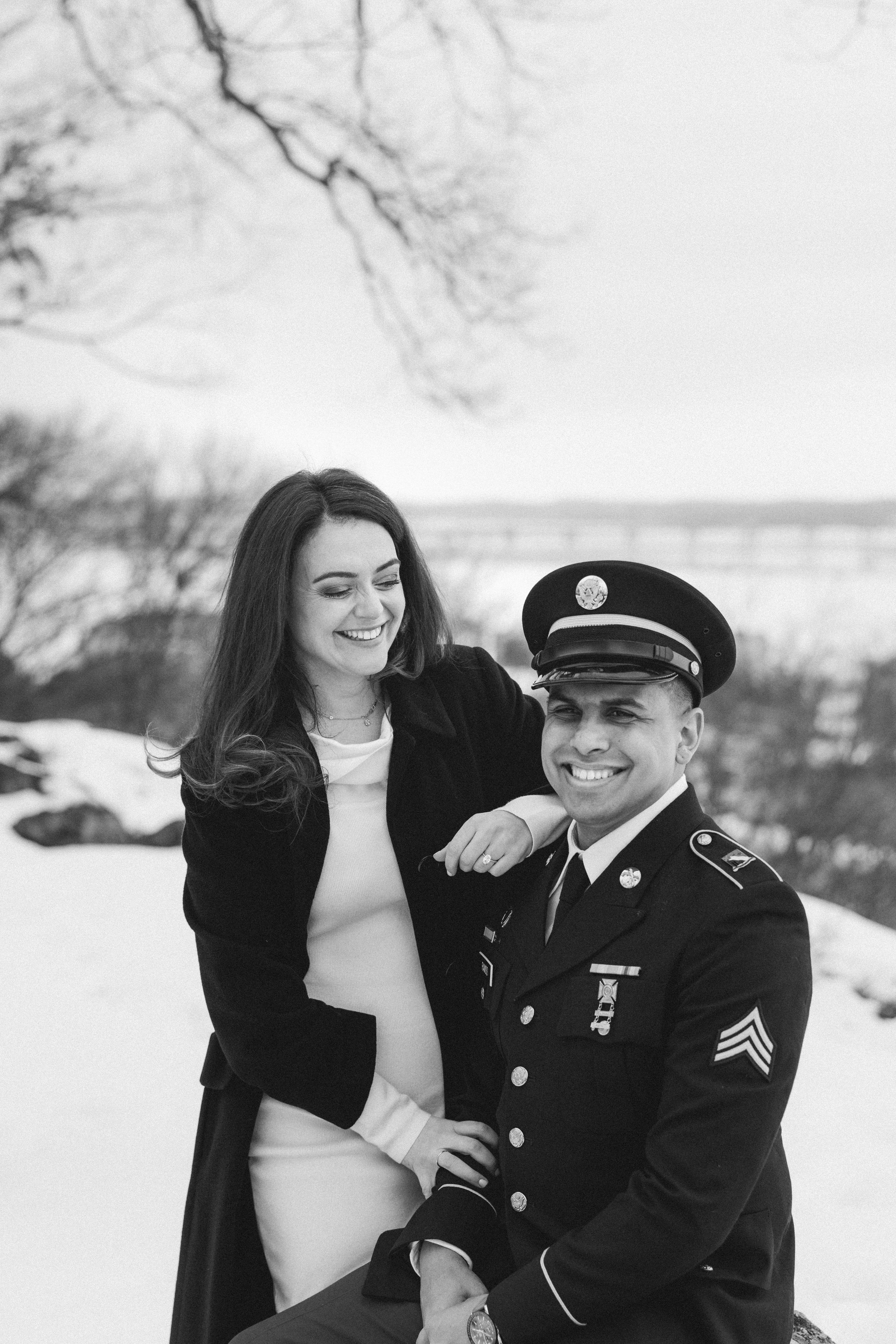 A couple shares joyful moments in a winter setting with one person wearing a military dress uniform.