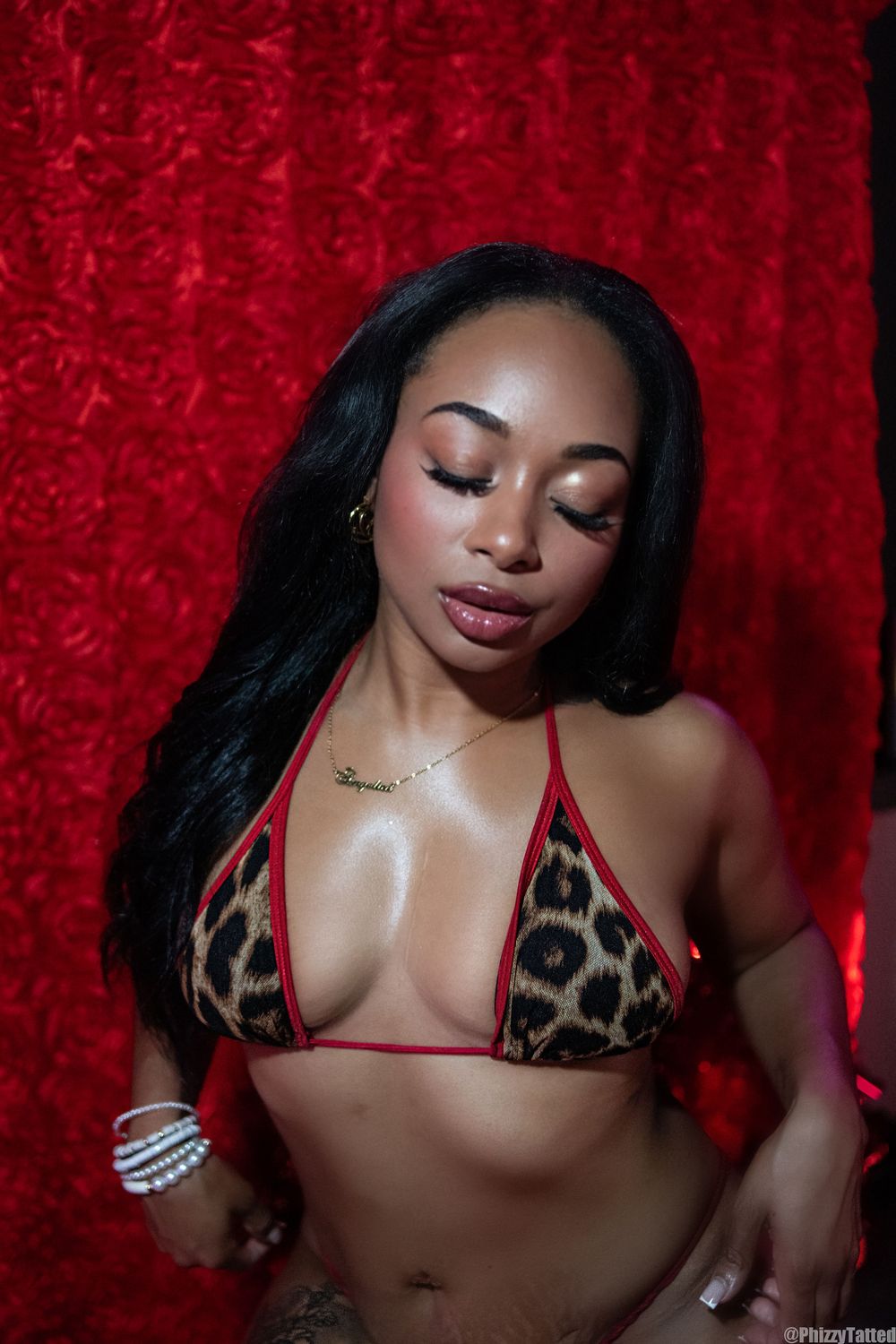 A glamour portrait against a red velvet backdrop featuring leopard print fashion.