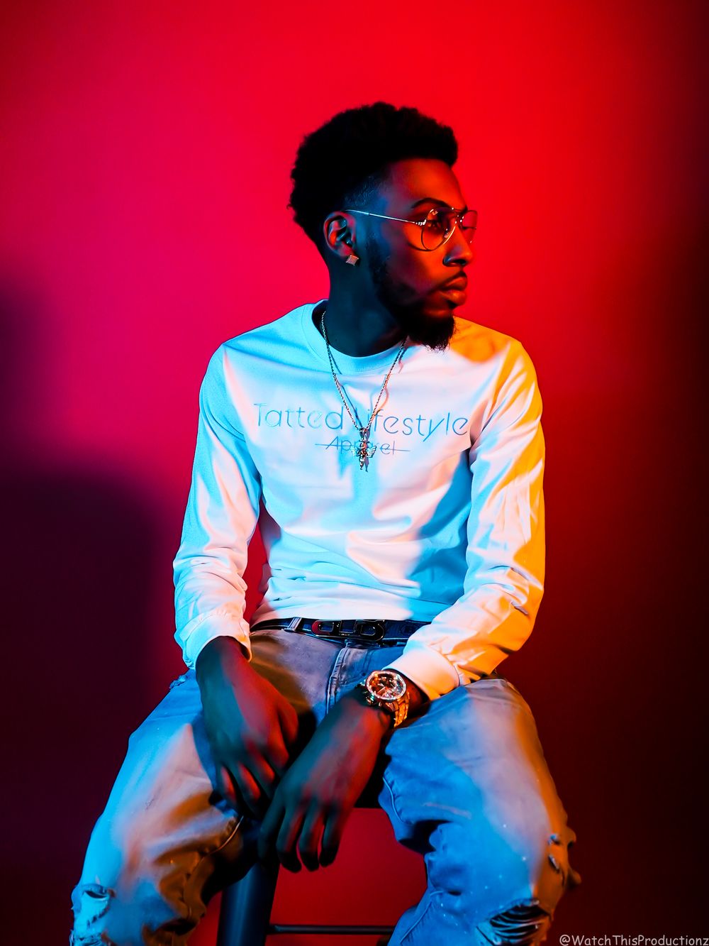 Fashion portrait with dramatic red and blue lighting effects.