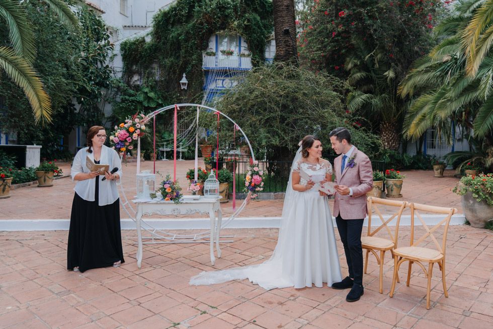 A romantic outdoor wedding ceremony in a tropical garden setting with elegant decor and natural greenery.