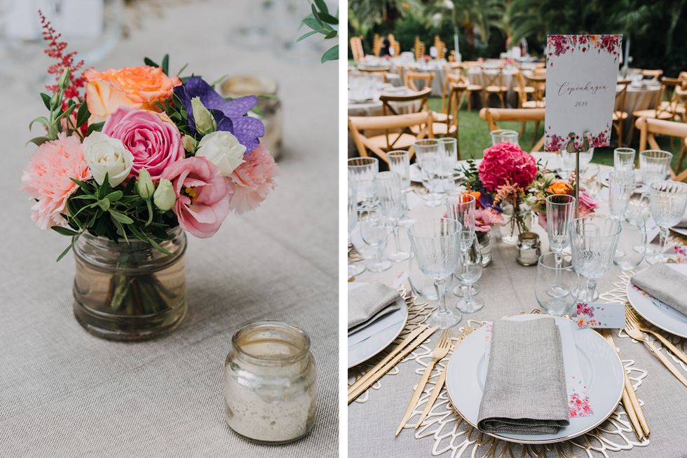 Rustic wedding table settings with mason jar flower centerpieces and elegant place settings for outdoor reception.