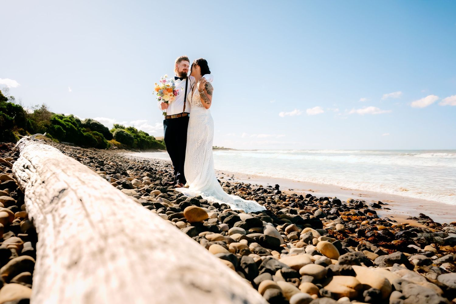A romantic wedding moment with a flowing veil in a dark industrial setting.
