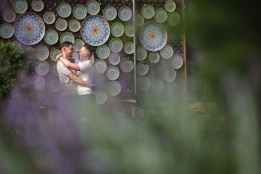Bokeh effect created by light and glass in green and purple tones creates a dreamy abstract background pattern.