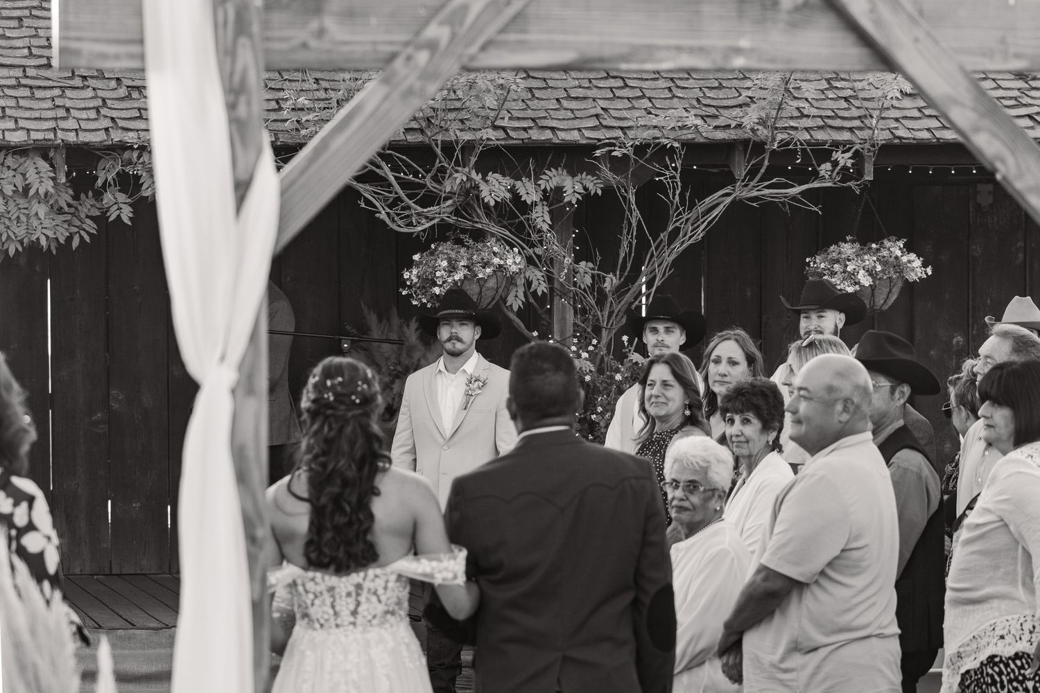Wedding guests dancing and celebrating at an indoor reception venue.