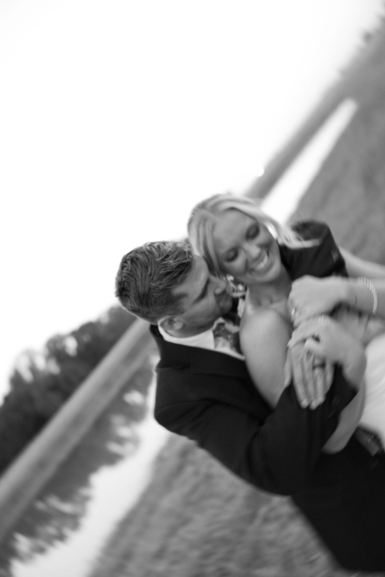 Black and white romantic portrait of a couple sharing an intimate moment.