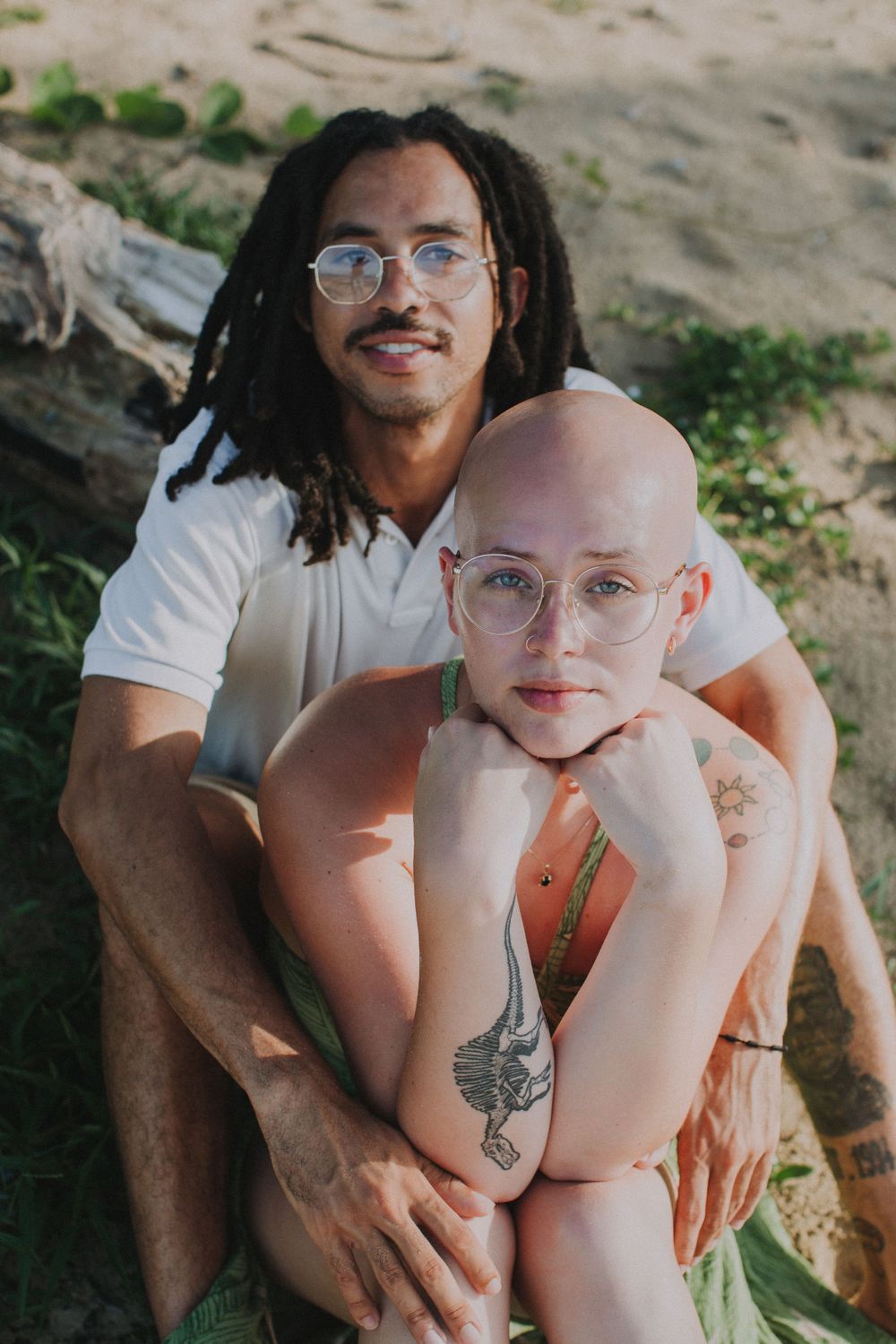 A couple sitting together outdoors sharing an intimate moment in natural lighting.