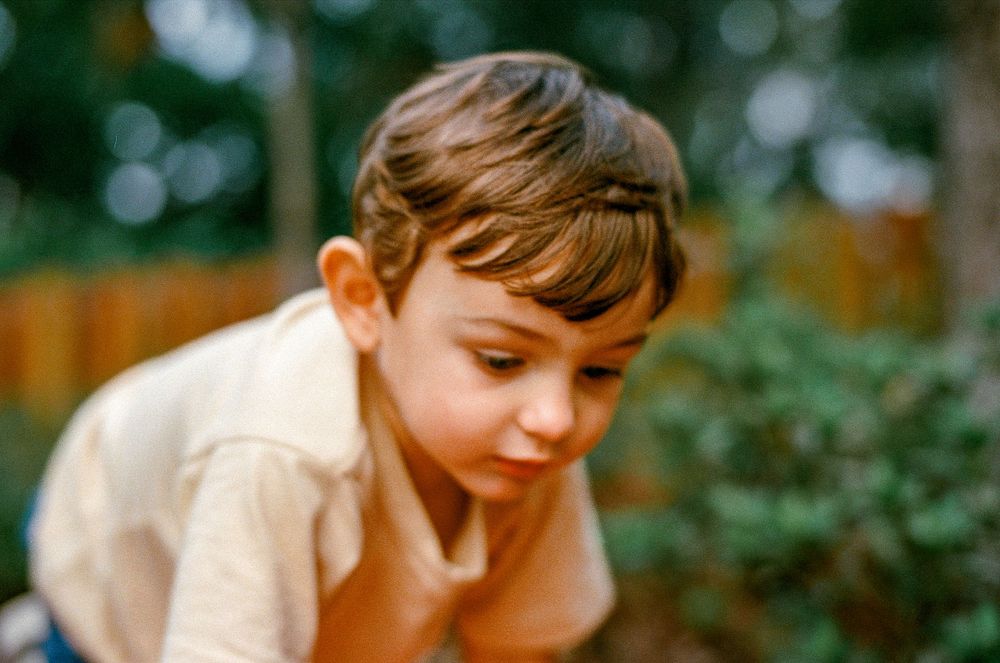 A vintage color photograph showing a close up candid portrait with a dreamy soft focus quality.