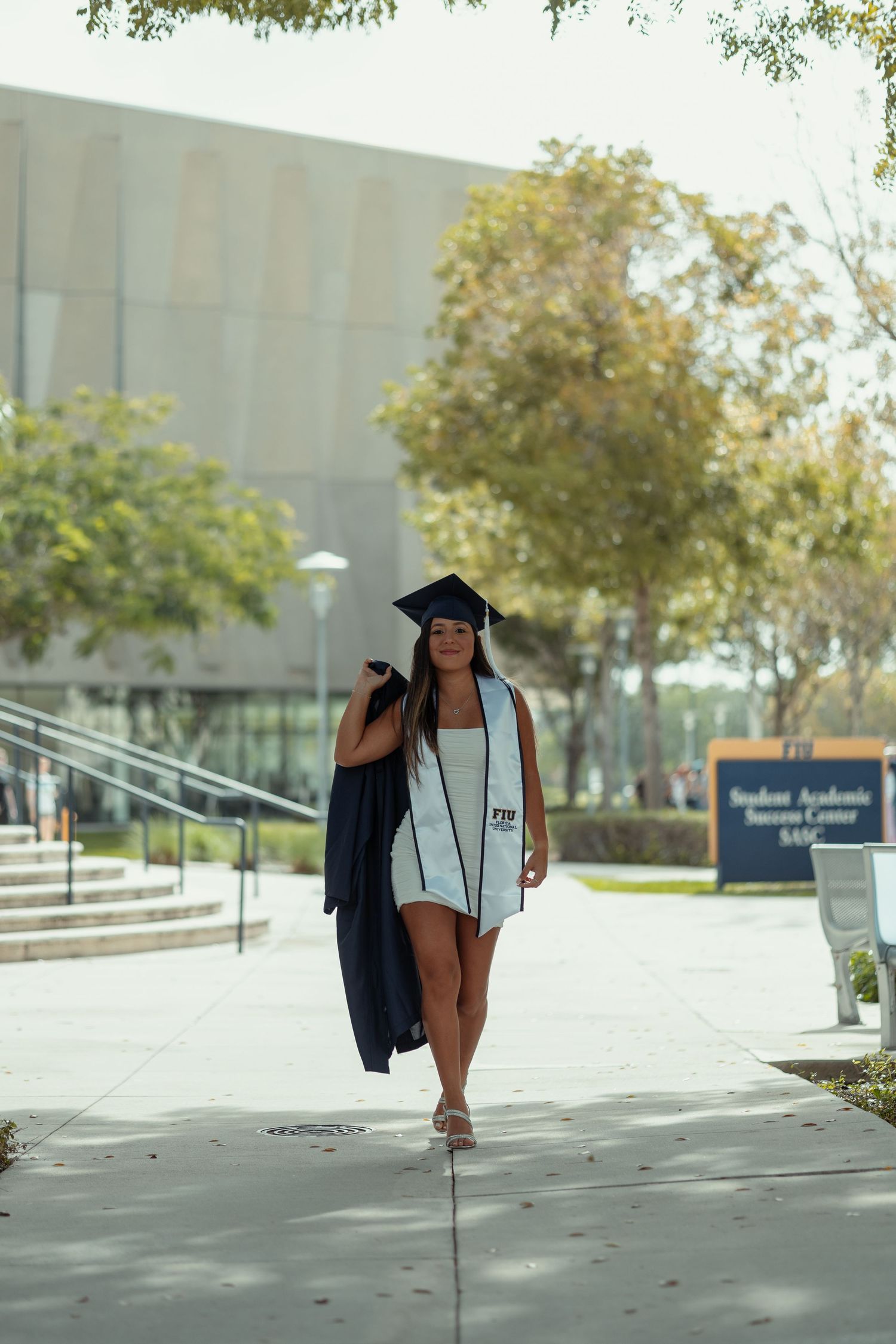 FIU graduation portrait in Miami – senior celebrating achievement with cap and gown, South Florida cinematic senior photography.
