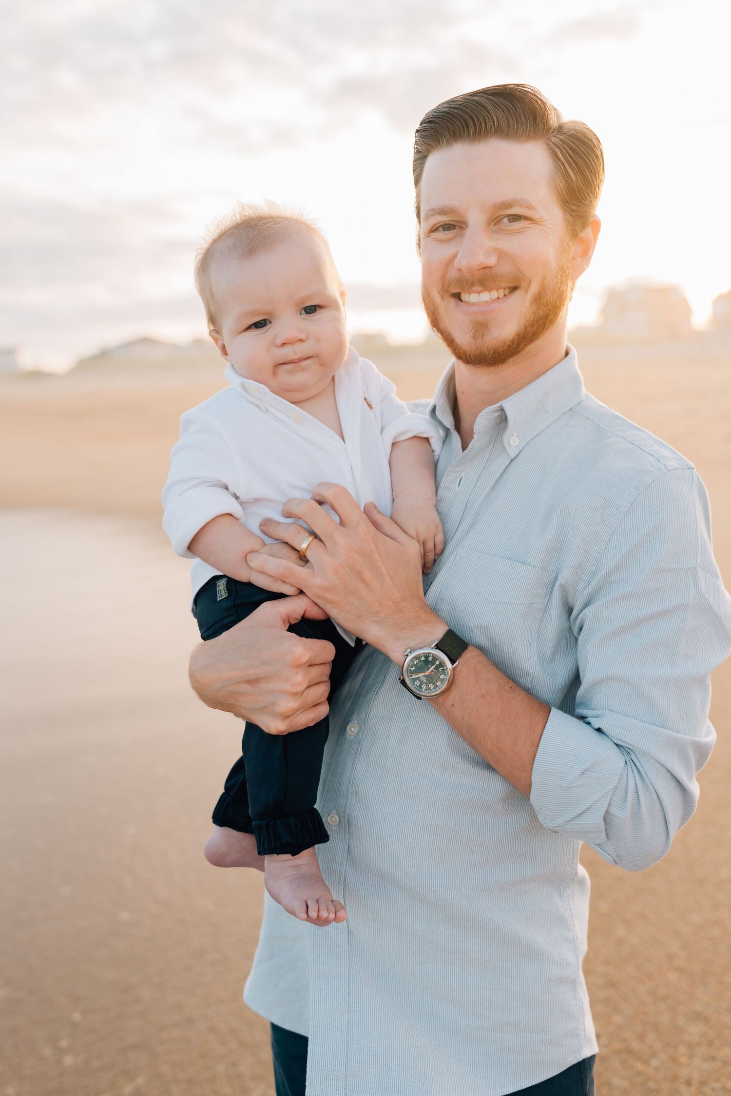A Belmar man embraces his one year old son for photos on the beach in Sea Girt, New Jersey by Lauren Marie Photography.