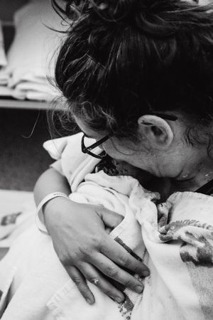 Intimate black and white photography capturing first moments with newborn.