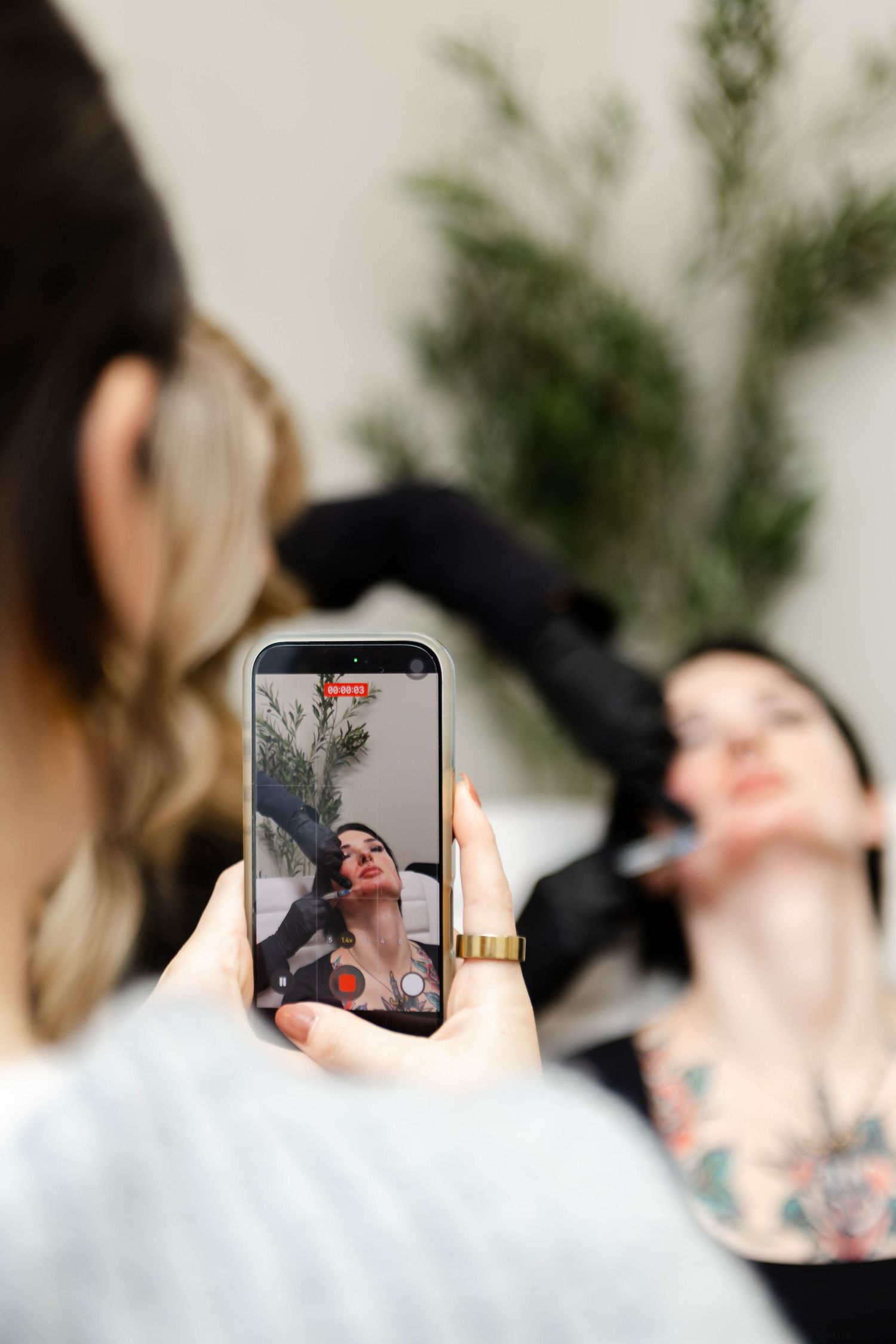 Someone taking photos with a smartphone during a special event.
