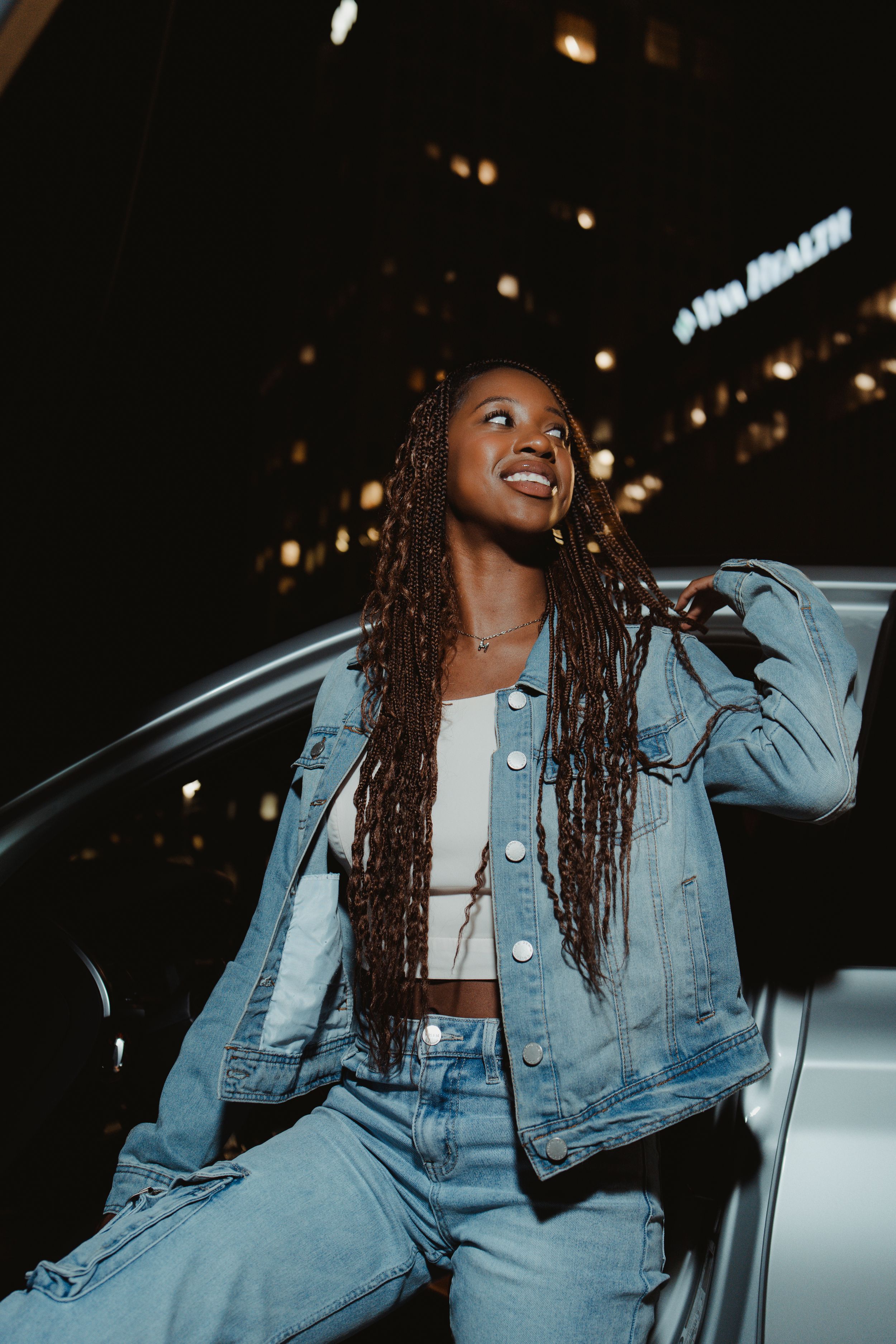 A series of night photos showing someone in a denim jacket laughing and posing against a car.