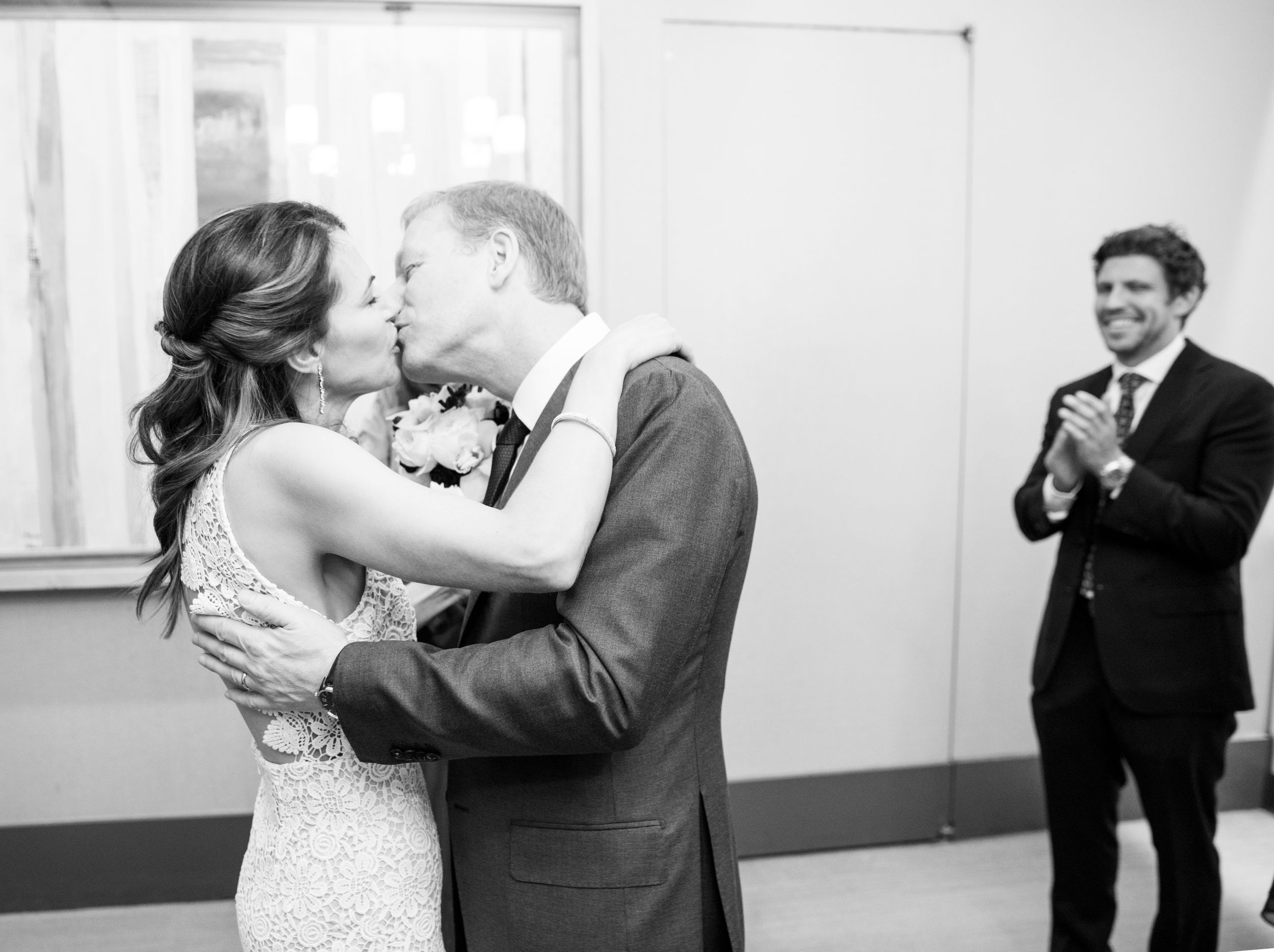 NYC City Hall Clerks office wedding celebration captured in black and white with elegant formal attire.