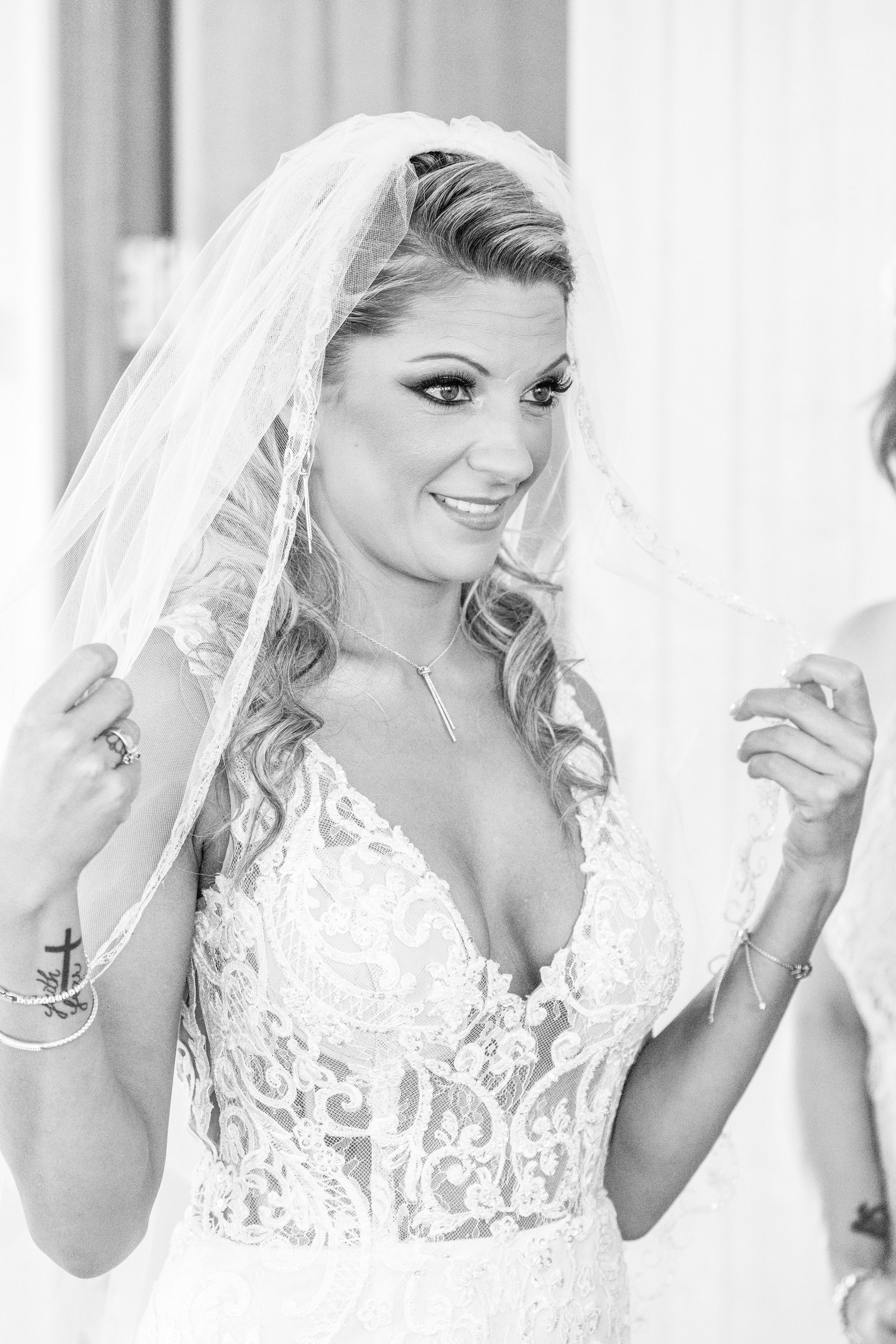 A wedding dress and veil detail in soft natural light.