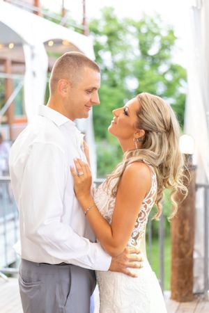 A joyful wedding moment captured under an outdoor pavilion.