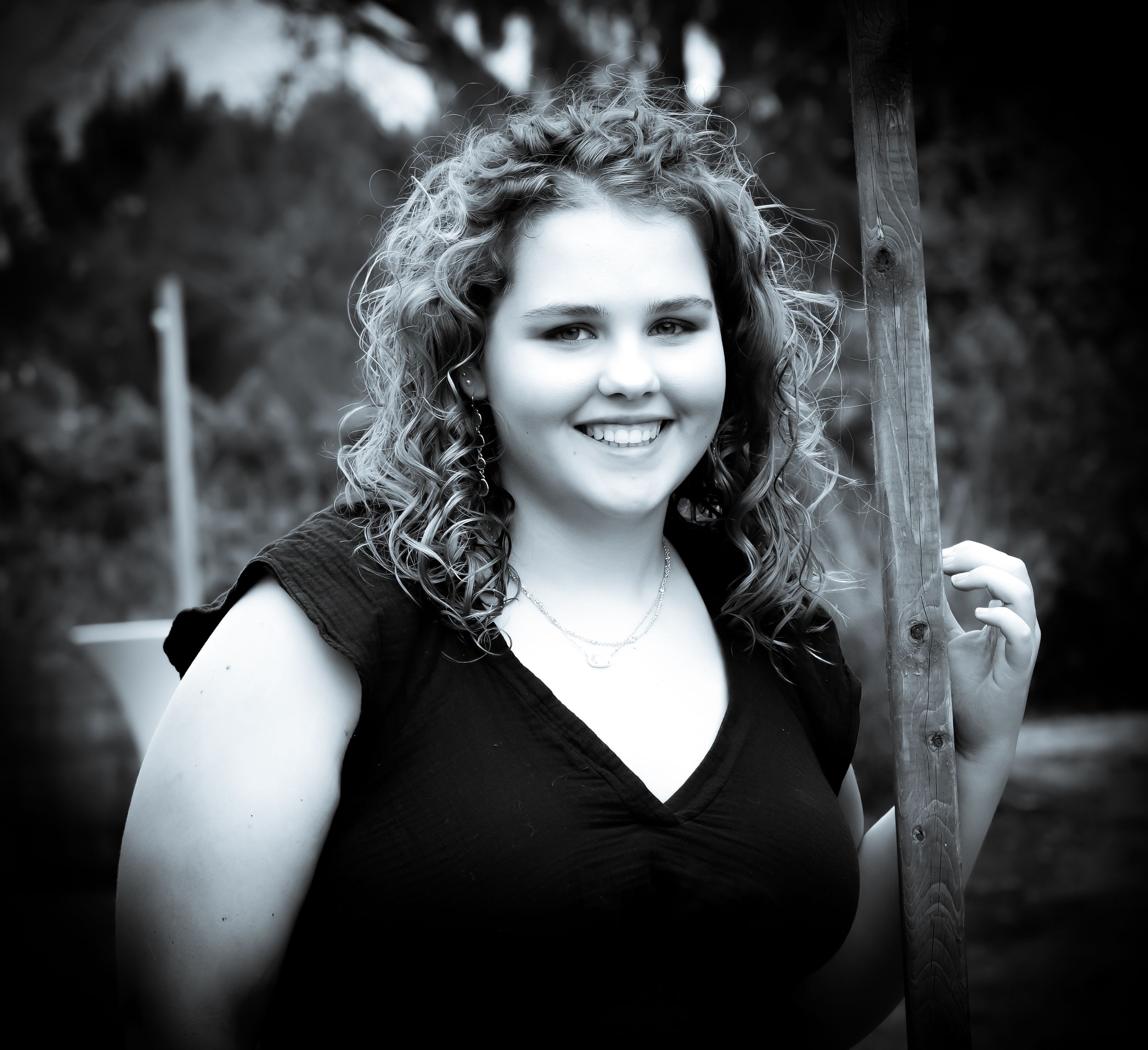 Black and white portrait showing curly hair and black dress.
senior photography
