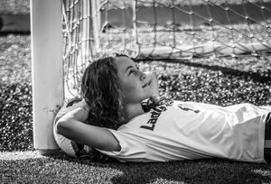 Black and white photo of athlete resting against soccer goal post.
senior photography
soccer senior