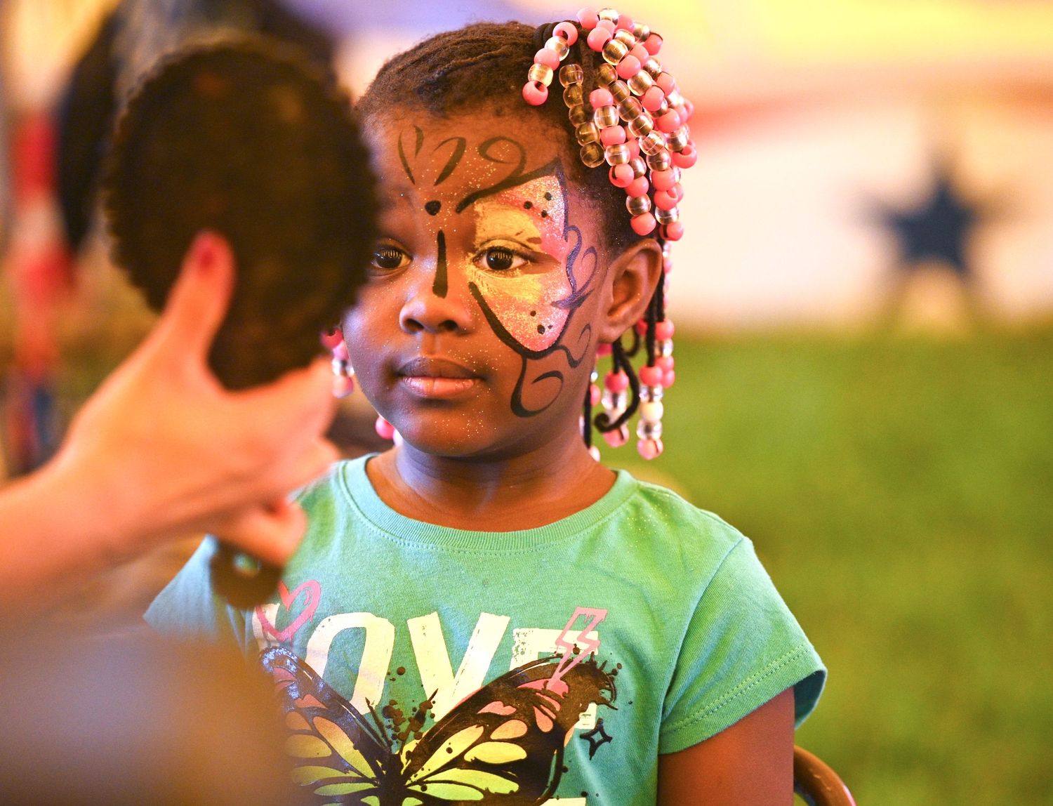 Young festival attendee with colorful butterfly face paint design | photo by Tom McCall Photography | Eastern Shore Maryland Photographer