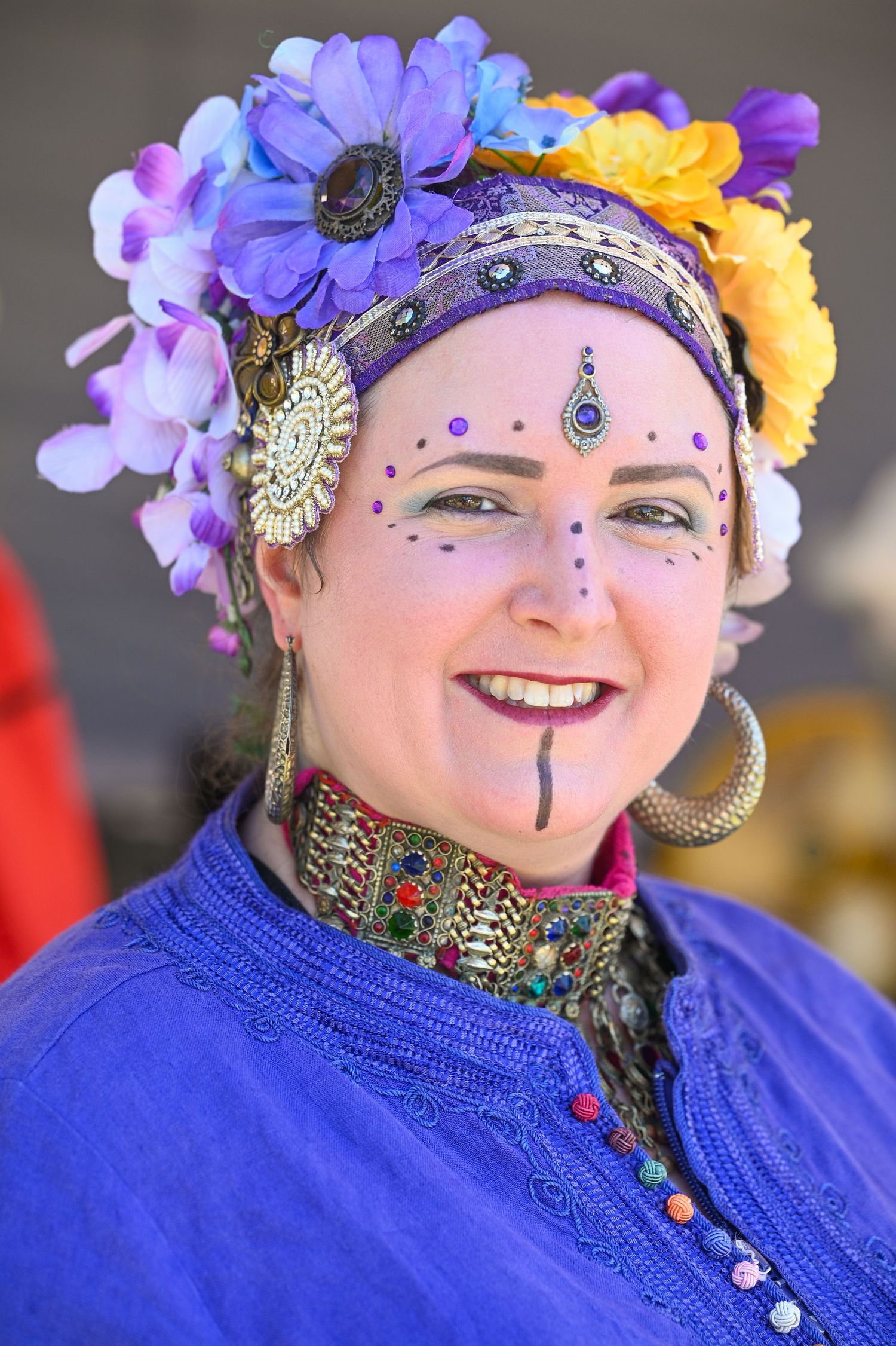 Festival performer wearing ornate blue costume with floral headdress and facial decorations | photo by Tom McCall Photography | Maryland