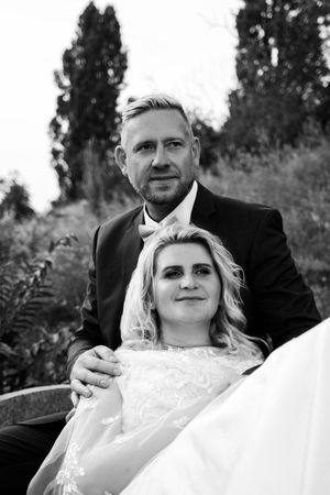 A black and white wedding photo sequence showing tender moments between a couple in formal attire.