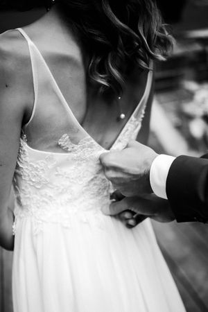 Black and white close-up sequence showing delicate lace details on a wedding dress bodice.