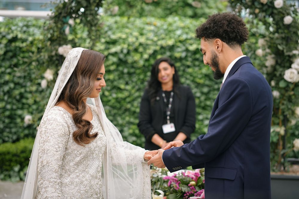 A romantic wedding ceremony series showing couple exchanging vows in a lush garden setting with white floral decorations.