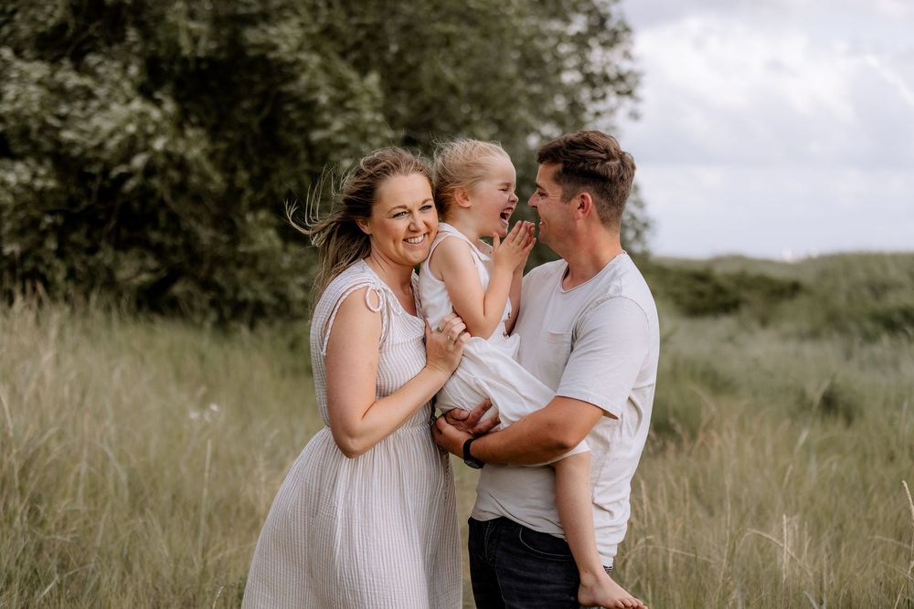 A family shares intimate moments together in a natural outdoor setting.