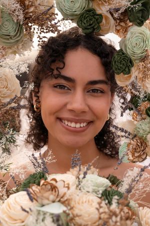 Beautiful portrait surrounded by a floral border with sage green and cream roses and dried flowers.