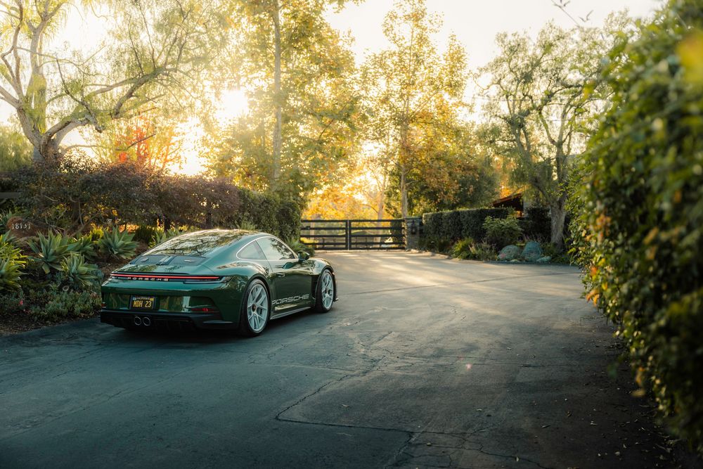Green Porsche 911 S/T parked at sunrise
