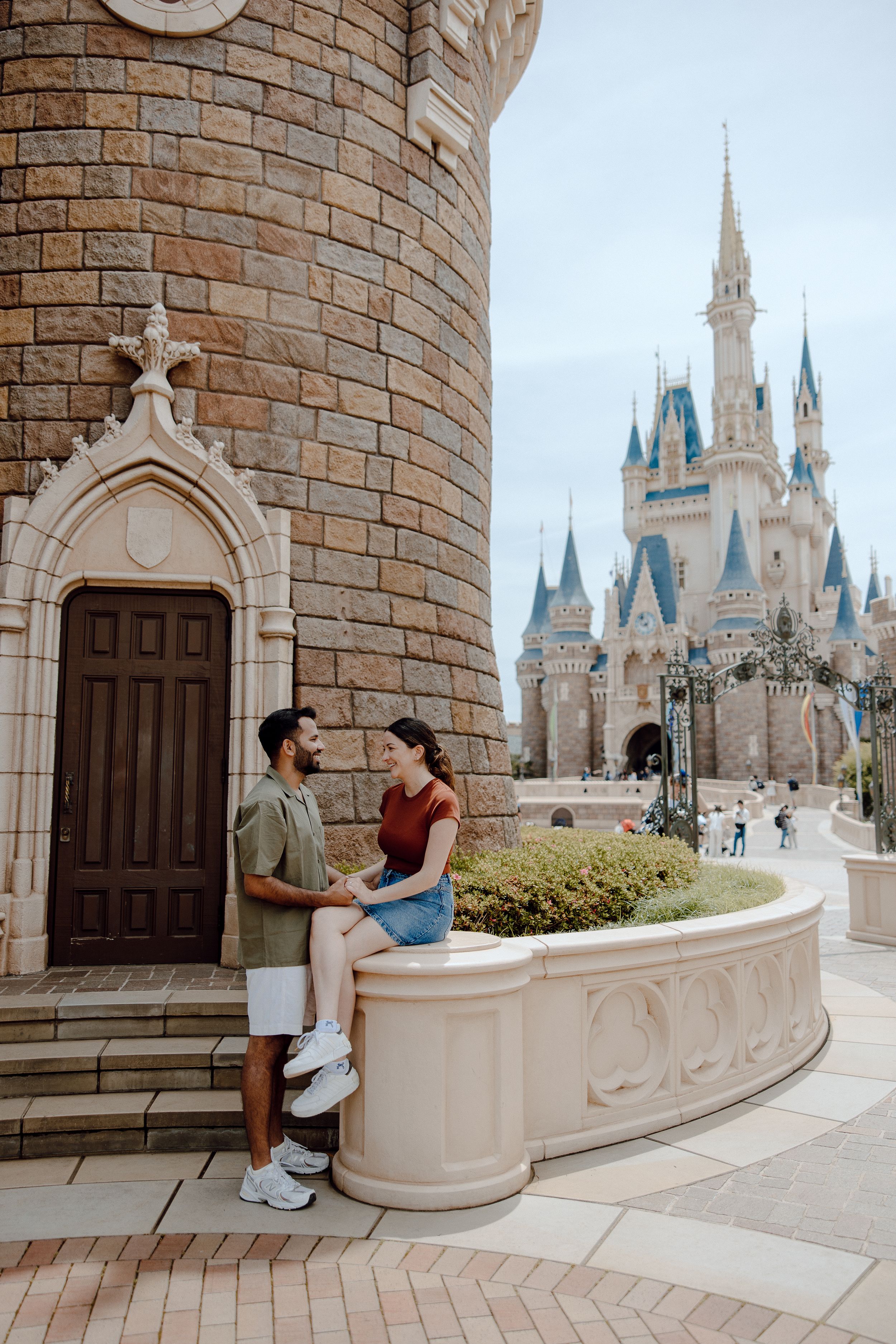 A couple shares a romantic moment at Walt Disney World Magic Kingdom with Cinderella Castle in the background.