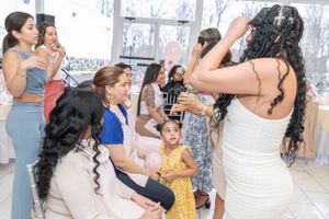 Party guests playing a fun game together at a baby shower celebration.