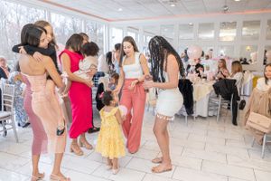 Party guests mingling and dancing at an elegant indoor celebration.