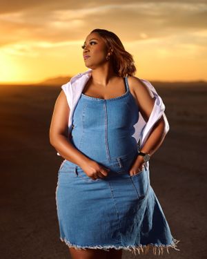 lady in a denim dress with a white sweater