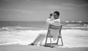 lady seating at the beach on a chair