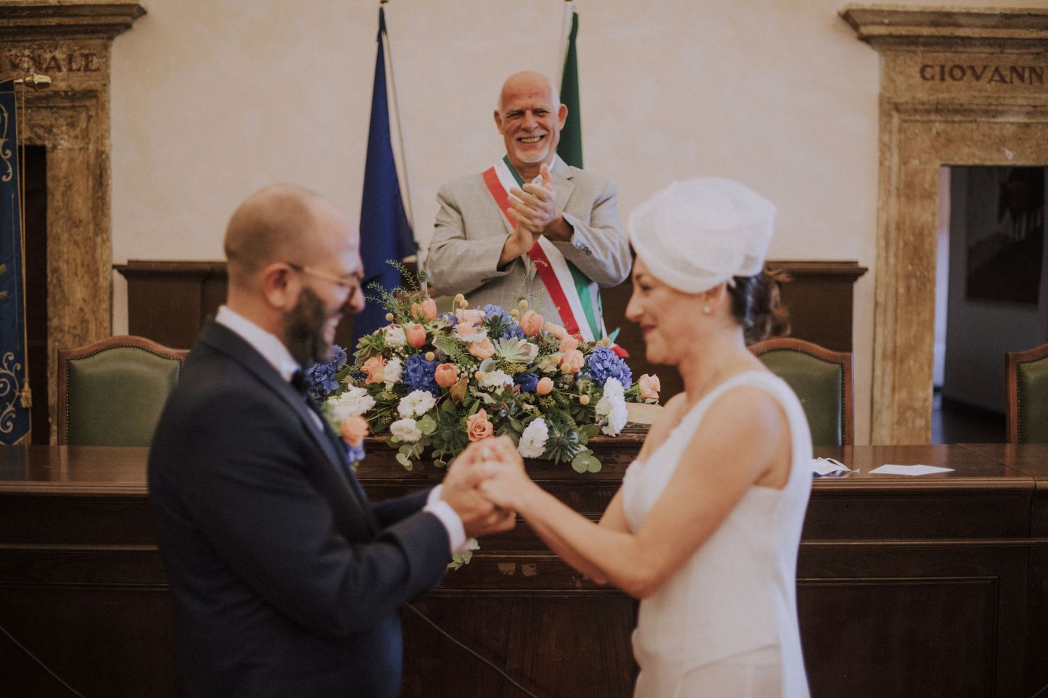 Close-up of hands touching during an intimate wedding ceremony moment.