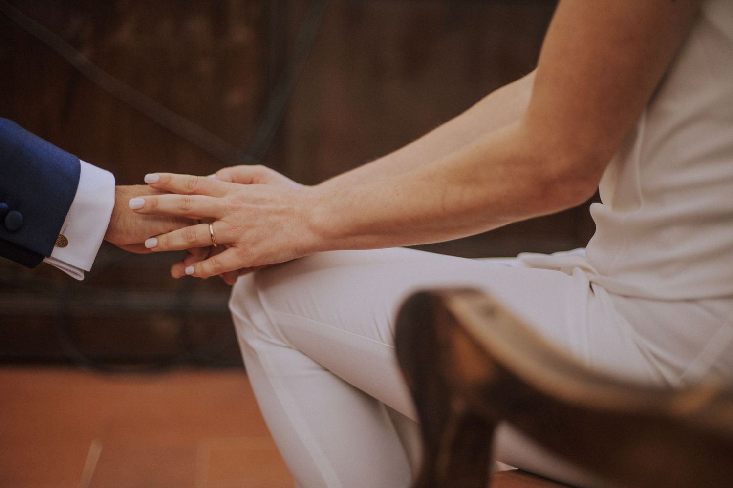 An intimate wedding ceremony moment in a softly lit church interior.