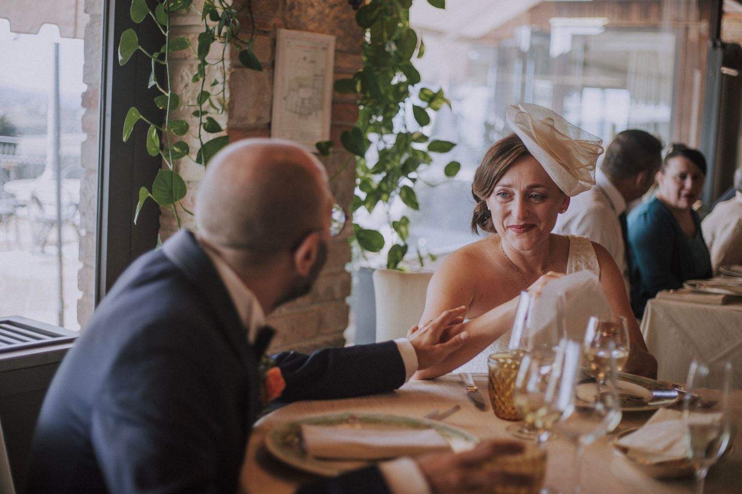 Intimate restaurant setting with natural lighting and elegant table arrangements.