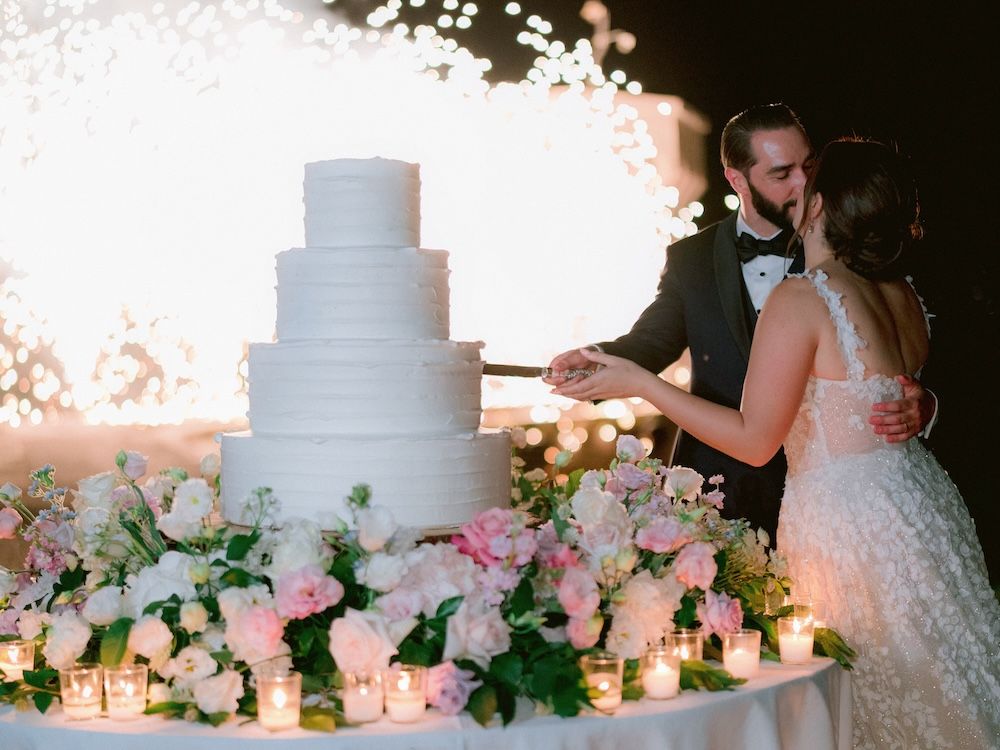 Luxury destination wedding reception on Isola del Garda with floral design in white, blush and gol