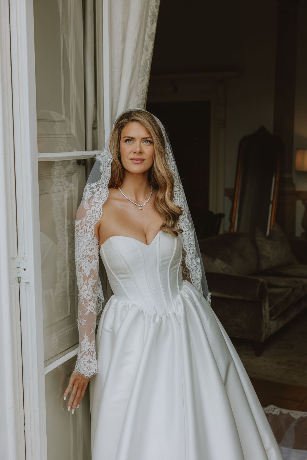 Elegant white wedding dress with sweetheart neckline and lace sleeves shown in multiple angles.