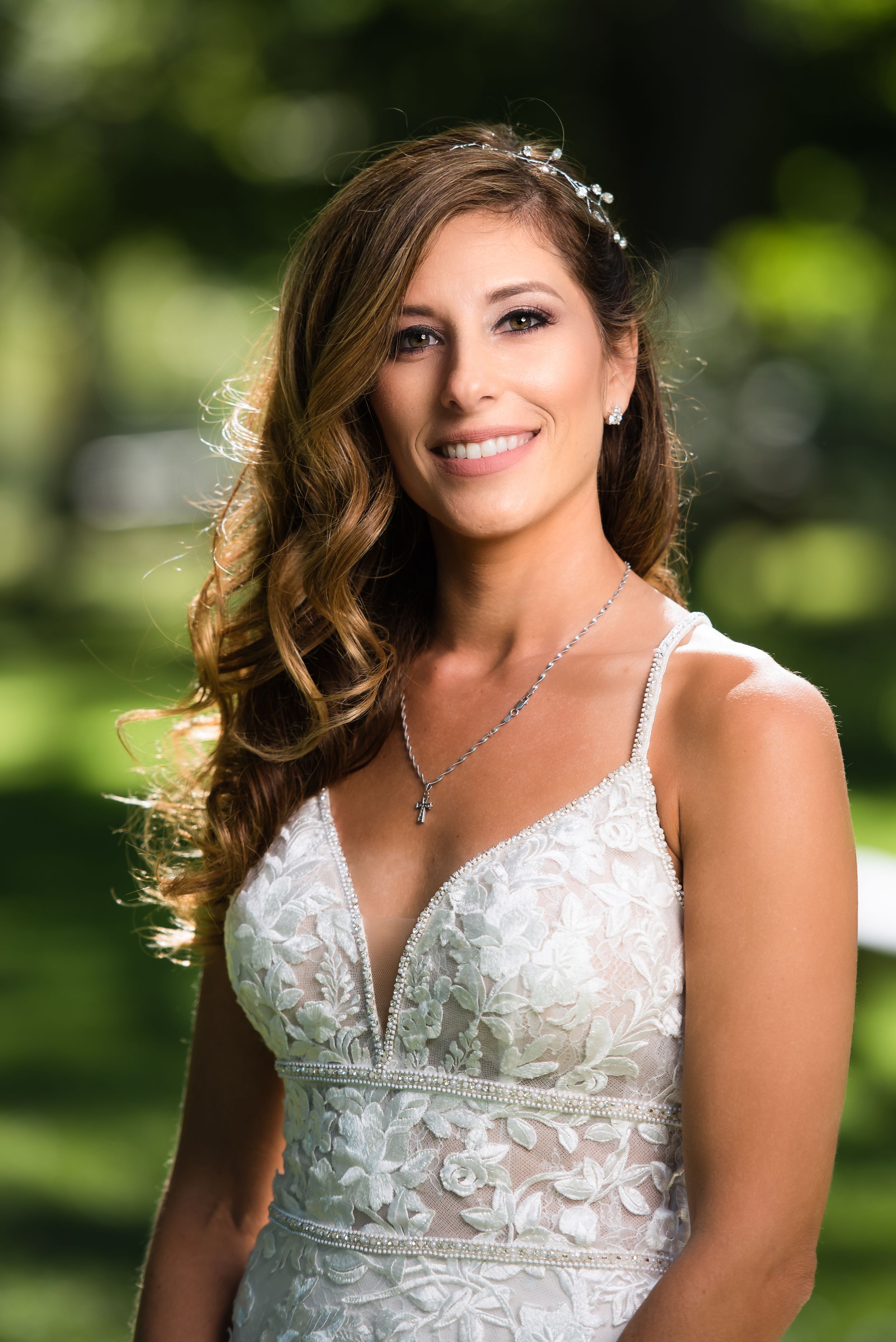 A series of outdoor portrait shots showing someone in a white lace wedding dress with delicate floral details.
